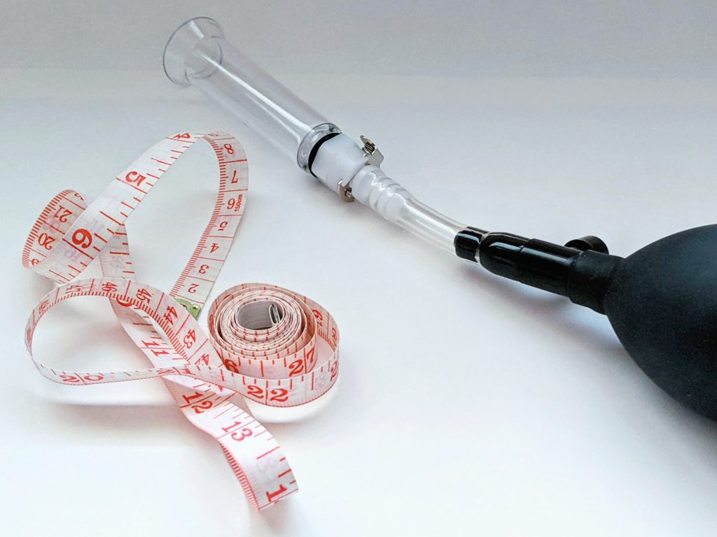 Part of the assembled pump is shown next to a measuring tape.